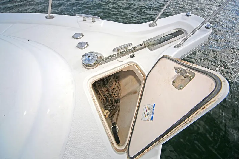 Slide: The Image of 2007 Tiara Yachts 3900 Sovran anchor locker with open hatch, showing ropes and anchor chain. - 14