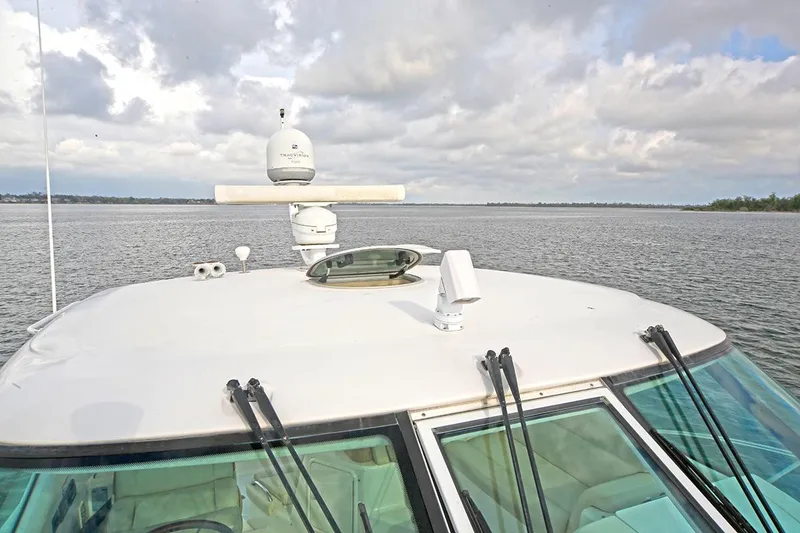 Slide: The Image of 2007 Tiara Yachts 3900 Sovran on calm waters under cloudy sky. - 17