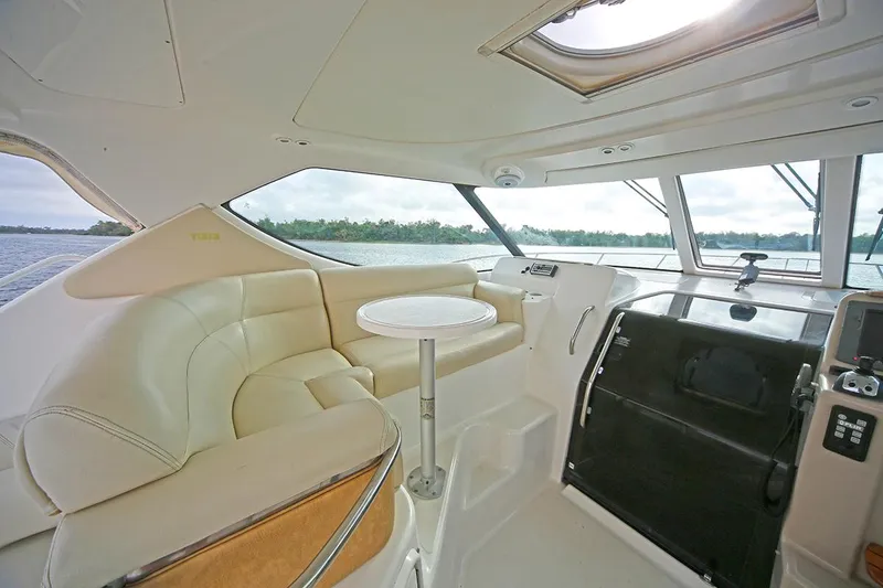 Slide: The Image of 2007 Tiara Yachts 3900 Sovran interior with plush seating and helm view. - 21
