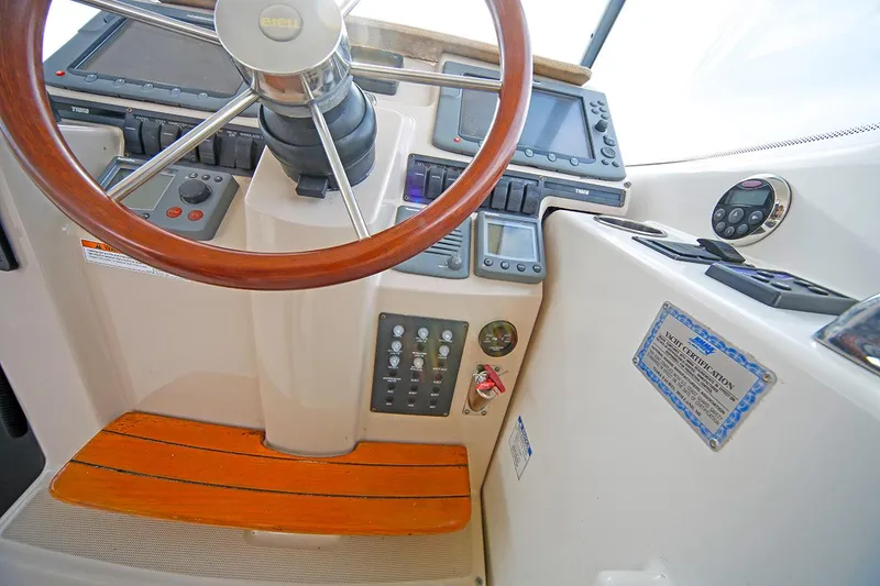 Slide: The Image of 2007 Tiara Yachts 3900 Sovran helm with wooden steering wheel and control panel. - 23