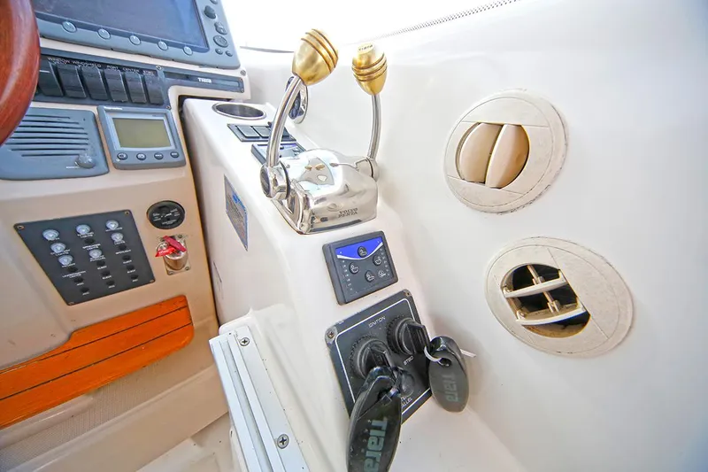 Slide: The Image of Control panel of a 2007 Tiara Yachts 3900 Sovran with throttle levers and navigation instruments. - 25