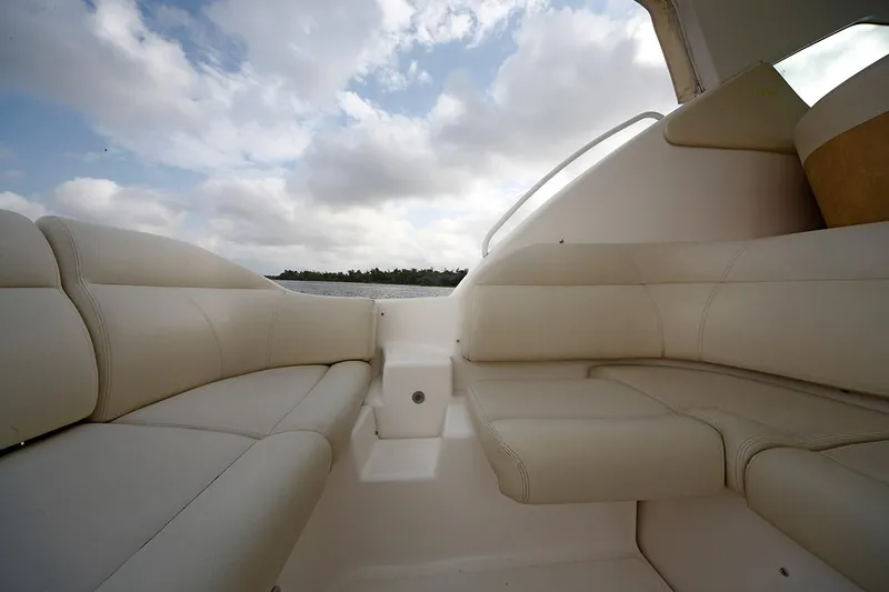 Slide: The Image of 2007 Tiara Yachts 3900 Sovran interior with plush seating under a cloudy sky. - 29