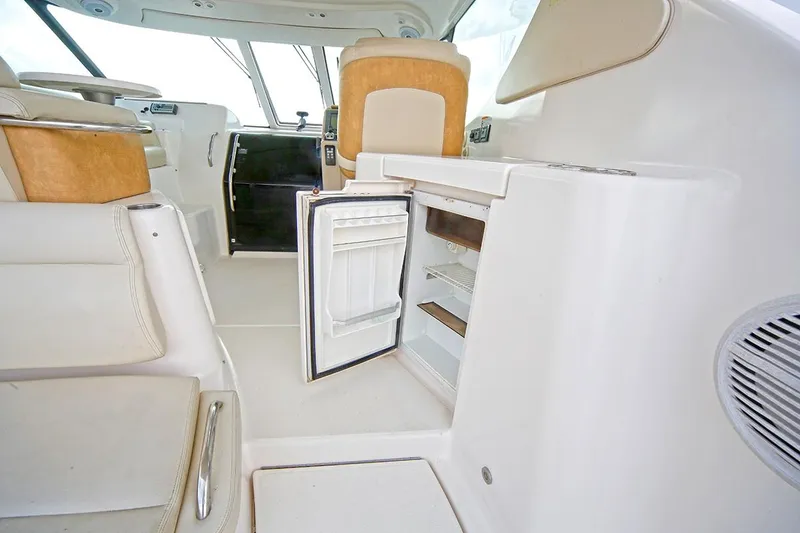 Slide: The Image of 2007 Tiara Yachts 3900 Sovran interior with open mini fridge and seating area. - 32