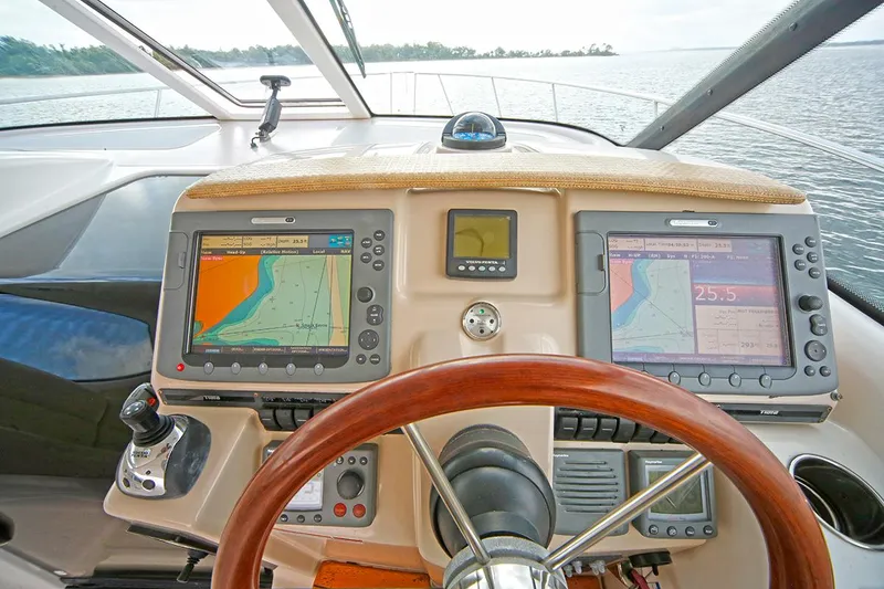 Slide: The Image of 2007 Tiara Yachts 3900 Sovran helm with navigation screens and wooden steering wheel. - 33