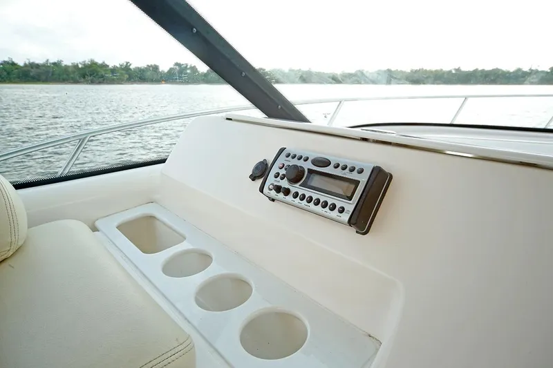 Slide: The Image of 2007 Tiara Yachts 3900 Sovran dashboard with radio and cup holders, overlooking water. - 37