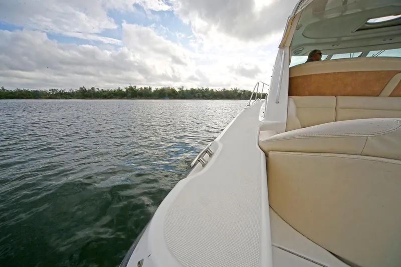 Slide: The Image of 2007 Tiara Yachts 3900 Sovran cruising on a calm lake under a cloudy sky. - 4