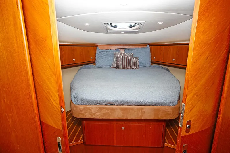 Slide: The Image of 2007 Tiara Yachts 3900 Sovran cabin with bed, wooden interior, and overhead hatch. - 44