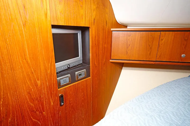 Slide: The Image of 2007 Tiara Yachts 3900 Sovran cabin with built-in TV and wooden cabinetry. - 45