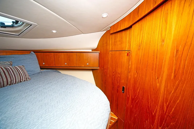 Slide: The Image of Luxurious cabin interior of 2007 Tiara Yachts 3900 Sovran with wood paneling and cozy bedding. - 46