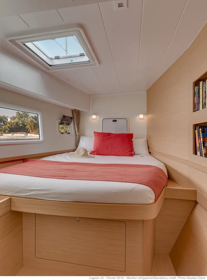Slide: The Image of Luxurious cabin interior of 2025 Lagoon 42 Millenium yacht with cozy bed and natural light. - 16