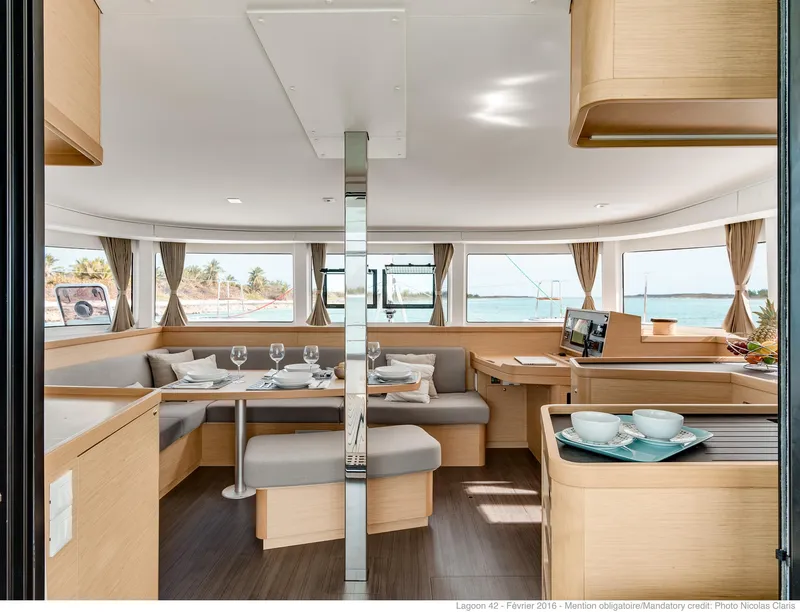Slide: The Image of Interior of 2025 Lagoon 42 Millenium yacht with elegant dining area and panoramic windows. - 6
