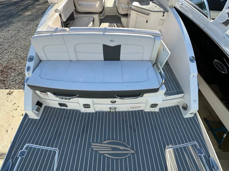 Slide: The Image of 2016 Chaparral 337SSX boat interior with seating and deck view. - 14