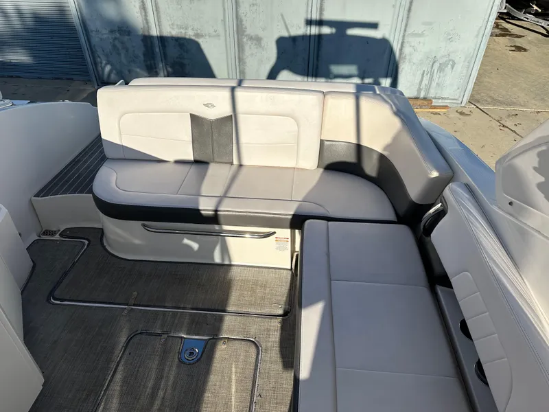 Slide: The Image of 2016 Chaparral 337SSX boat interior with white seating and gray flooring. - 19