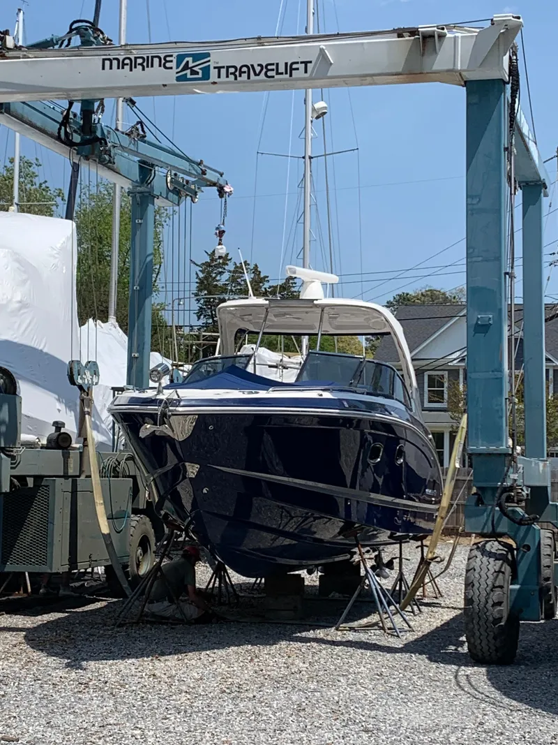 Slide: The Image of 2016 Chaparral 337SSX boat on a Marine Travelift at a marina. - 2