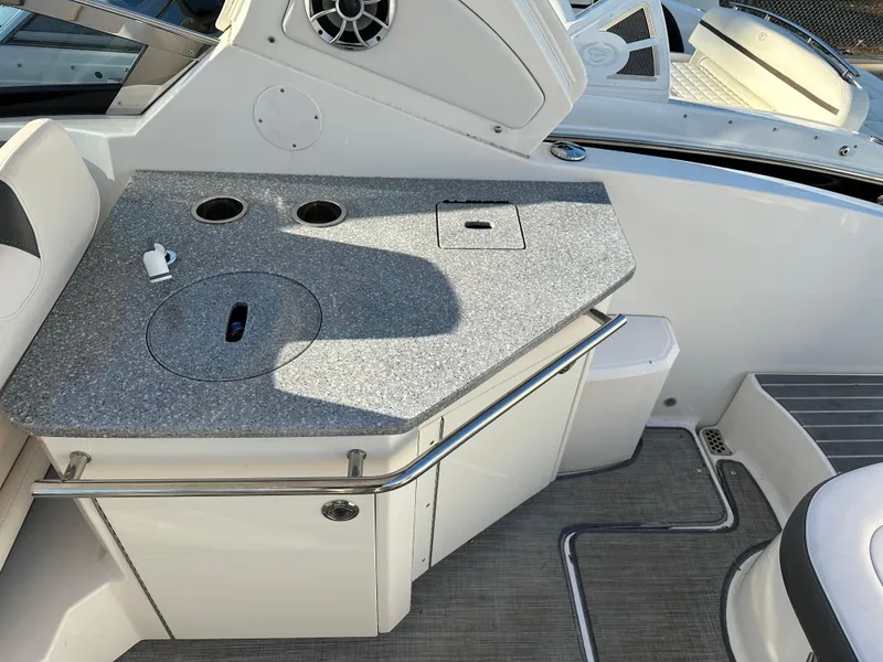 Slide: The Image of 2016 Chaparral 337SSX boat interior with a sleek countertop and built-in speaker. - 20