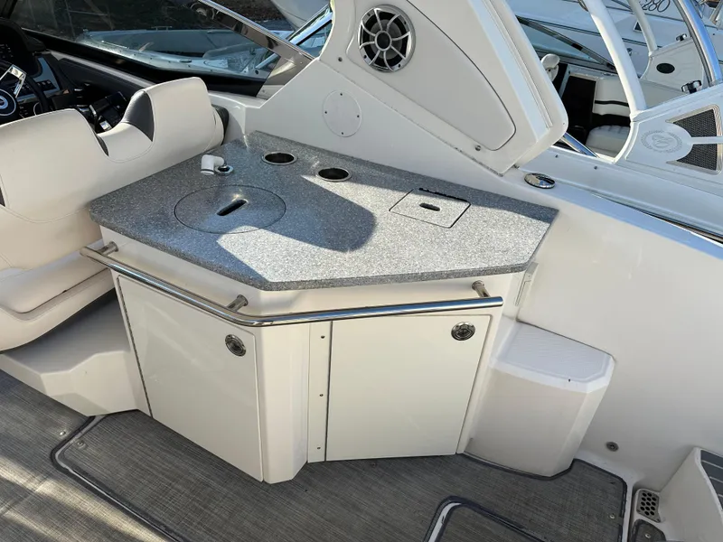 Slide: The Image of 2016 Chaparral 337SSX boat interior with sleek countertop and seating area. - 21