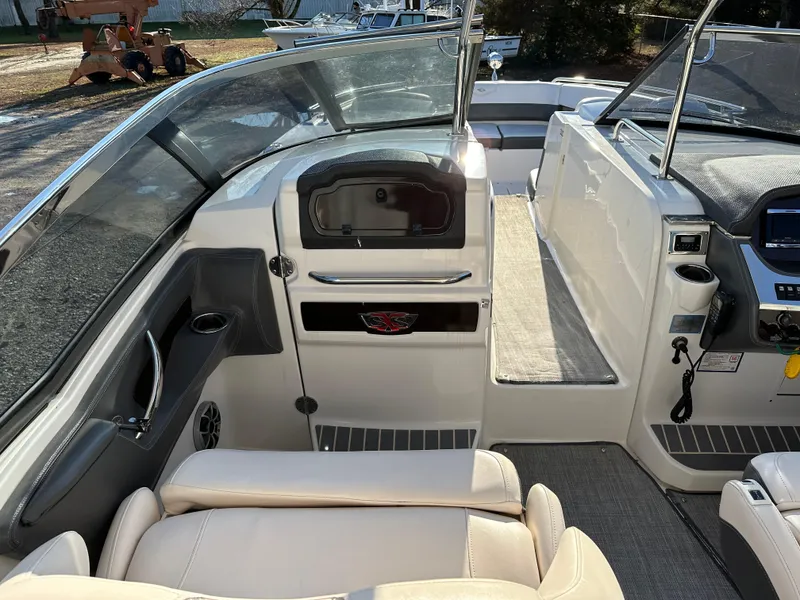 Slide: The Image of 2016 Chaparral 337SSX boat interior with seating and control panel. - 22