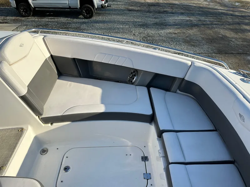 Slide: The Image of 2016 Chaparral 337SSX boat interior with white and gray seating. - 28