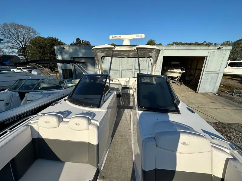 Slide: The Image of 2016 Chaparral 337SSX boat docked, featuring sleek design and spacious seating. - 30