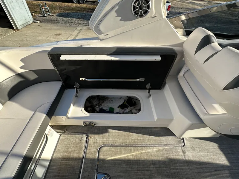 Slide: The Image of 2016 Chaparral 337SSX boat interior with open storage compartment. - 39