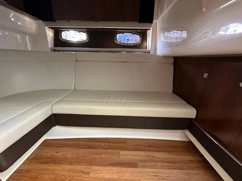 Slide: The Image of Interior of 2016 Chaparral 337SSX boat with white seating and wood flooring. - 43