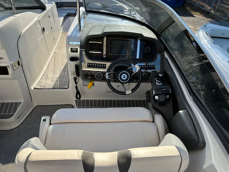 Slide: The Image of 2016 Chaparral 337SSX boat cockpit with steering wheel and control panel. - 6