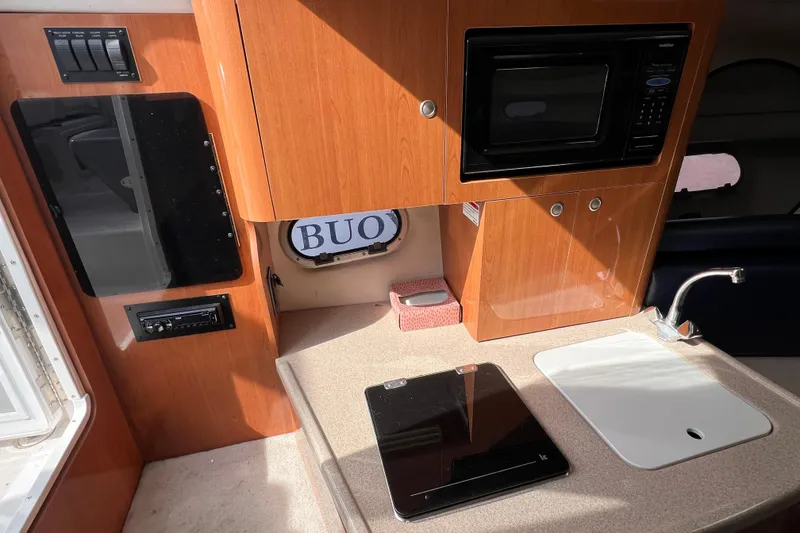 Slide: The Image of 2001 Four Winns 268 Vista boat interior with kitchenette, microwave, and sink. - 10