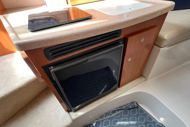 Slide: The Image of Interior of 2001 Four Winns 268 Vista boat with kitchenette and mini fridge. - 11