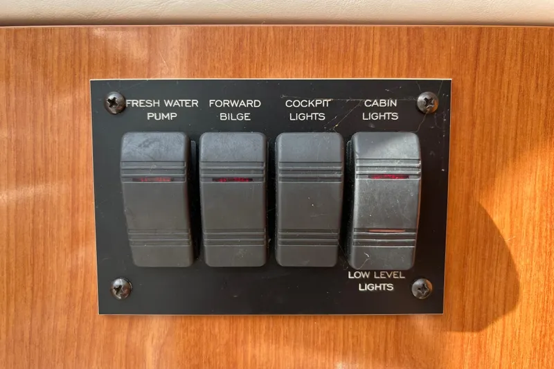 Slide: The Image of Control panel on 2001 Four Winns 268 Vista boat with switches for water pump and lights. - 12