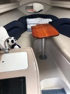 Slide: The Image of 2001 Four Winns 268 Vista boat on stands, outdoors under a partly cloudy sky. - 3