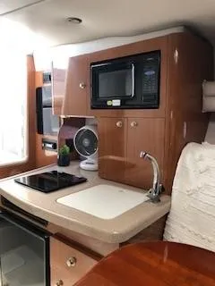 Slide: The Image of 2001 Four Winns 268 Vista boat on display, featuring a sleek white and blue design. - 4