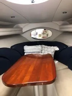 Slide: The Image of 2001 Four Winns 268 Vista boat with blue cover, parked on a trailer. - 5