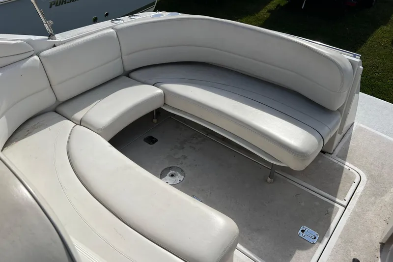 Slide: The Image of 2001 Four Winns 268 Vista boat with white cushioned seating area. - 6