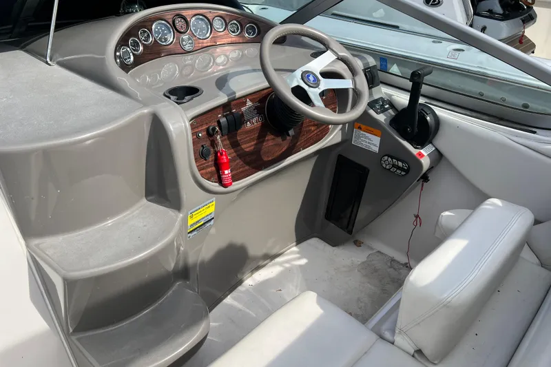 Slide: The Image of 2001 Four Winns 268 Vista boat cockpit with steering wheel and control panel. - 7