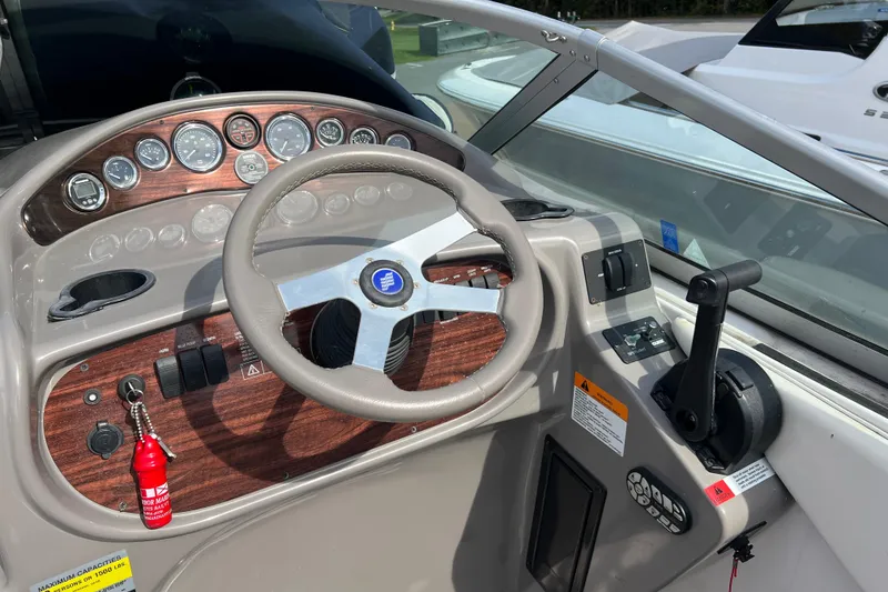 Slide: The Image of 2001 Four Winns 268 Vista boat dashboard with steering wheel and control panel. - 8