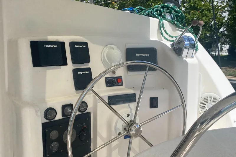 Slide: The Image of Steering wheel and control panel of a 2003 Leopard 38 catamaran. - 10