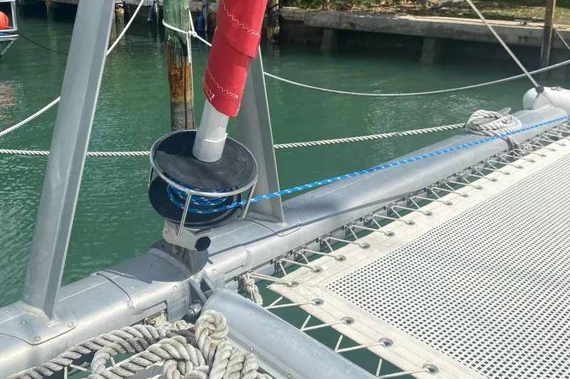 Slide: The Image of Catamaran deck detail, Leopard 38, 2003 model, featuring rigging and netting over water. - 13