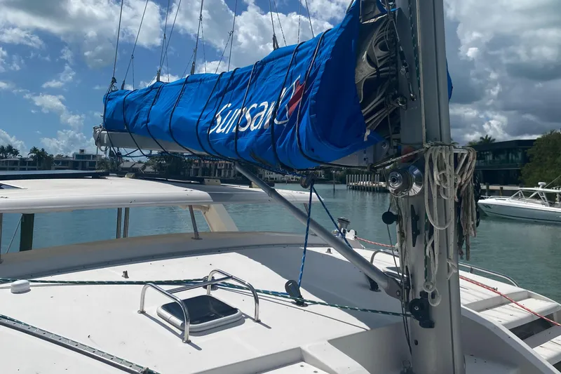 Slide: The Image of 2003 Leopard 38 catamaran with blue sail cover docked in sunny marina. - 15