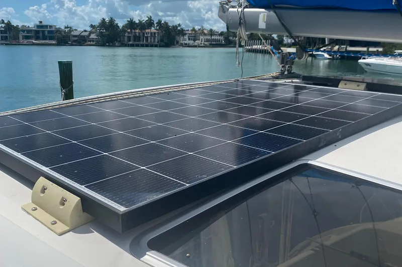 Slide: The Image of Solar panel on 2003 Leopard 38 catamaran, docked by waterfront homes. - 22