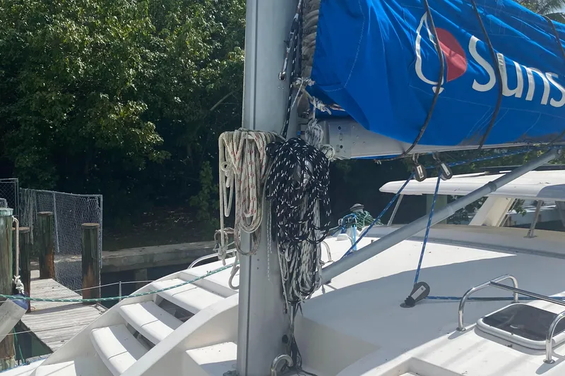 Slide: The Image of Leopard 38 sailboat, 2003 model, docked with ropes and blue sail cover. - 24