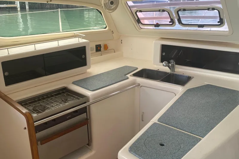 Slide: The Image of Interior of 2003 Leopard 38 yacht kitchen with stove, sink, and countertops. - 30