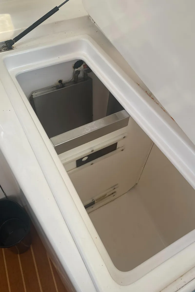 Slide: The Image of Open storage compartment on a 2003 Leopard 38 boat, featuring a white interior. - 34