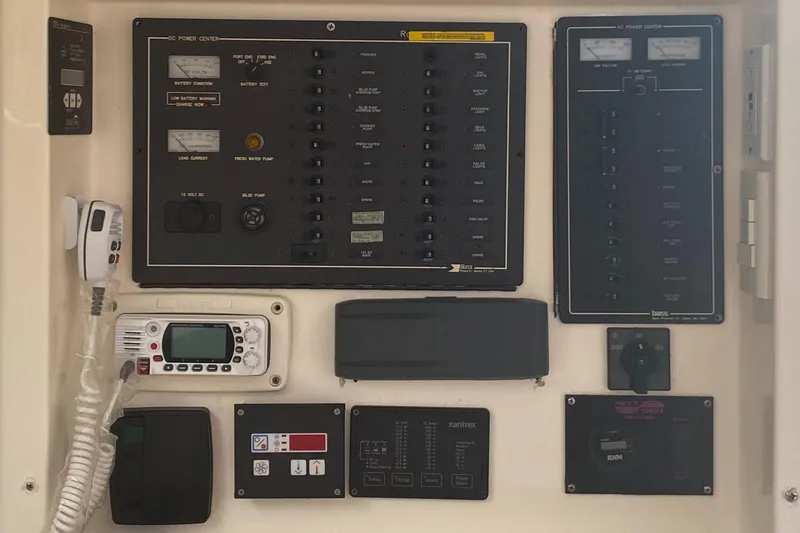 Slide: The Image of Control panel of a 2003 Leopard 38 yacht with various switches and gauges. - 36