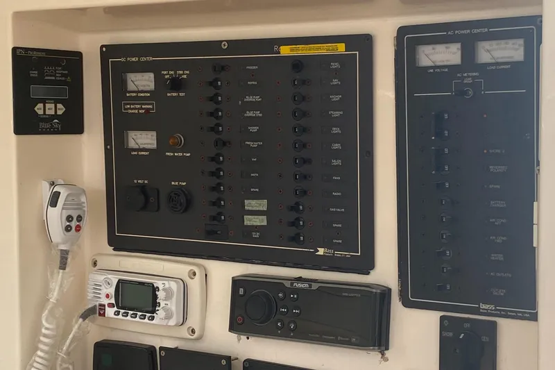 Slide: The Image of Electrical control panel on a 2003 Leopard 38 yacht, featuring various switches and gauges. - 38