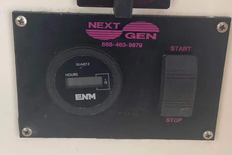 Slide: The Image of Control panel of a 2003 Leopard 38 with hour meter and start/stop switch. - 39