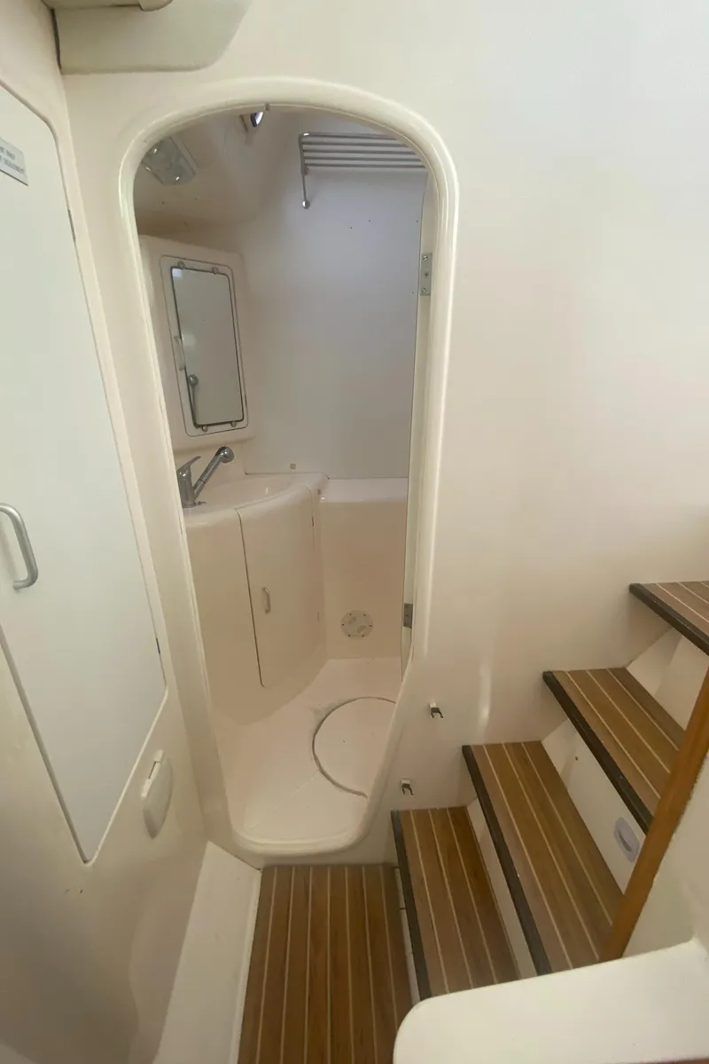 Slide: The Image of 2003 Leopard 38 yacht interior with wooden steps and compact bathroom. - 42