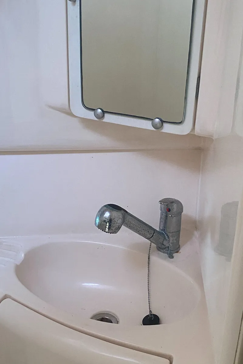 Slide: The Image of Small bathroom sink with mirror in 2003 Leopard 38 boat. - 46