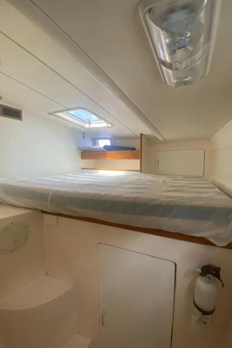 Slide: The Image of 2003 Leopard 38 yacht interior cabin with bed and storage. - 49