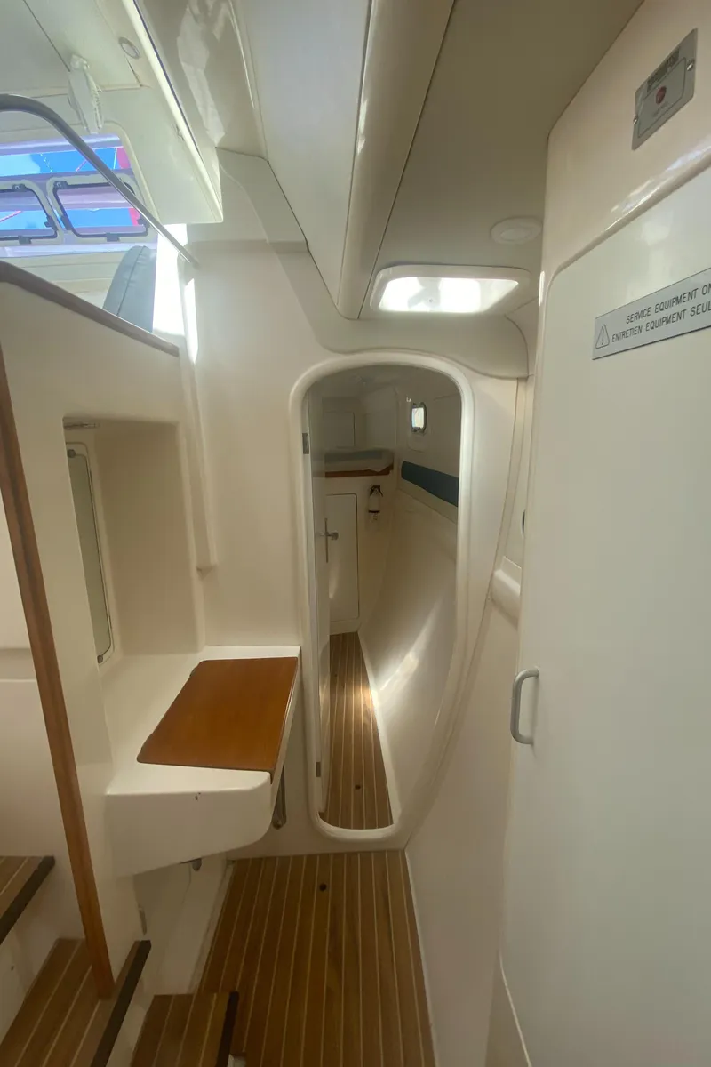 Slide: The Image of Interior of a 2003 Leopard 38 catamaran, featuring sleek design and wooden flooring. - 50