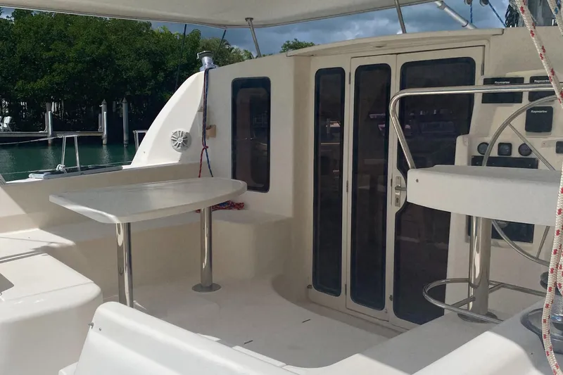 Slide: The Image of 2003 Leopard 38 yacht cockpit with seating and table, featuring modern design and spacious layout. - 6